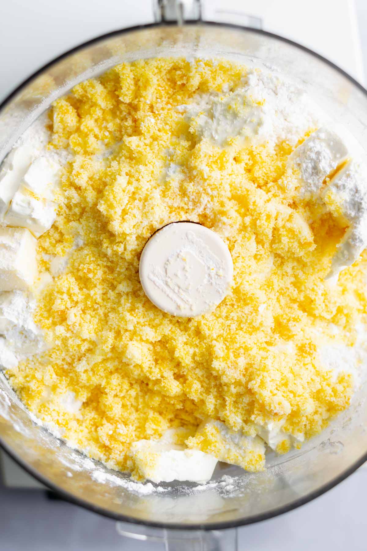 orange sugar, butter and cream cheese added to a food processor bowl