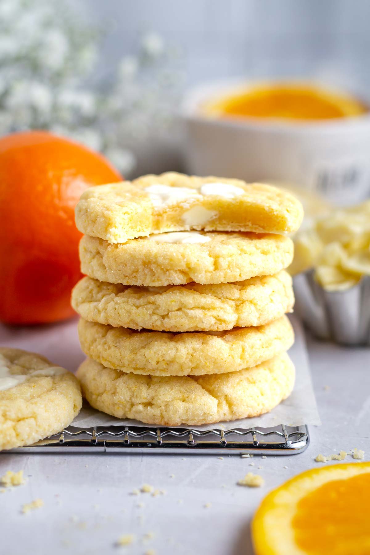 stack of orange creamsicle cookies with one missing a bite