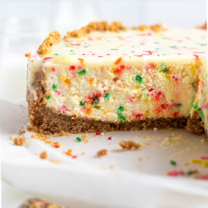 inside look at birthday cheesecake with white chocolate ganache topping