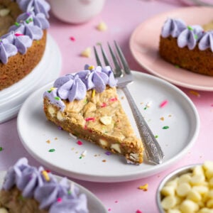 slice of birthday cookie cake on a plate with a fork