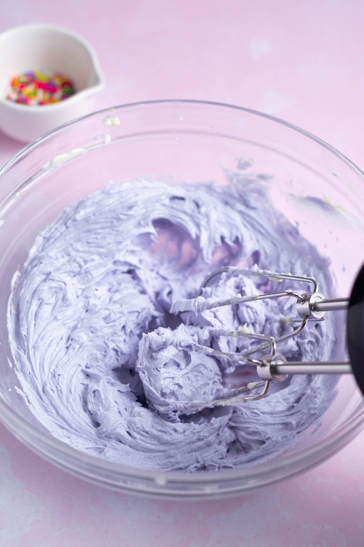 purple frosting in a mixing bowl