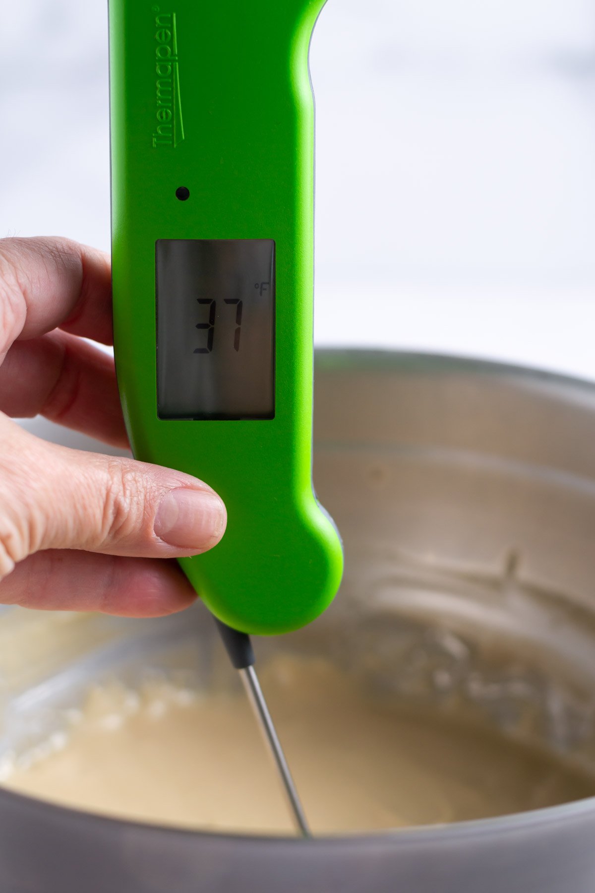 thermometer showing the chilled butterscotch ice cream base before churning.