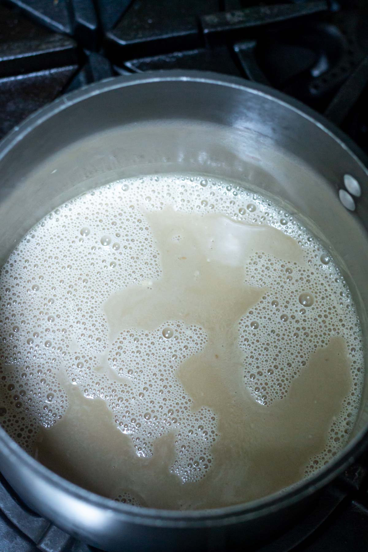 granulated sugar, brown sugar, half and half and milk in a sauce pan on the stove.