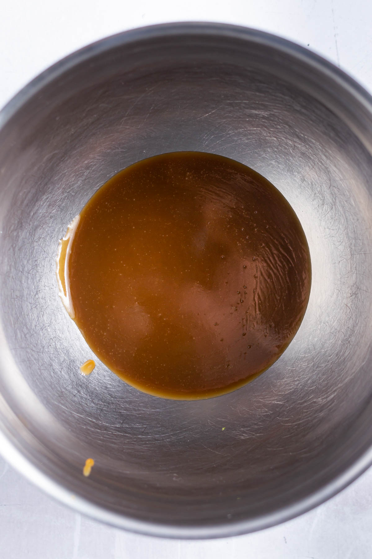 butterscotch in the bottom of a metal bowl