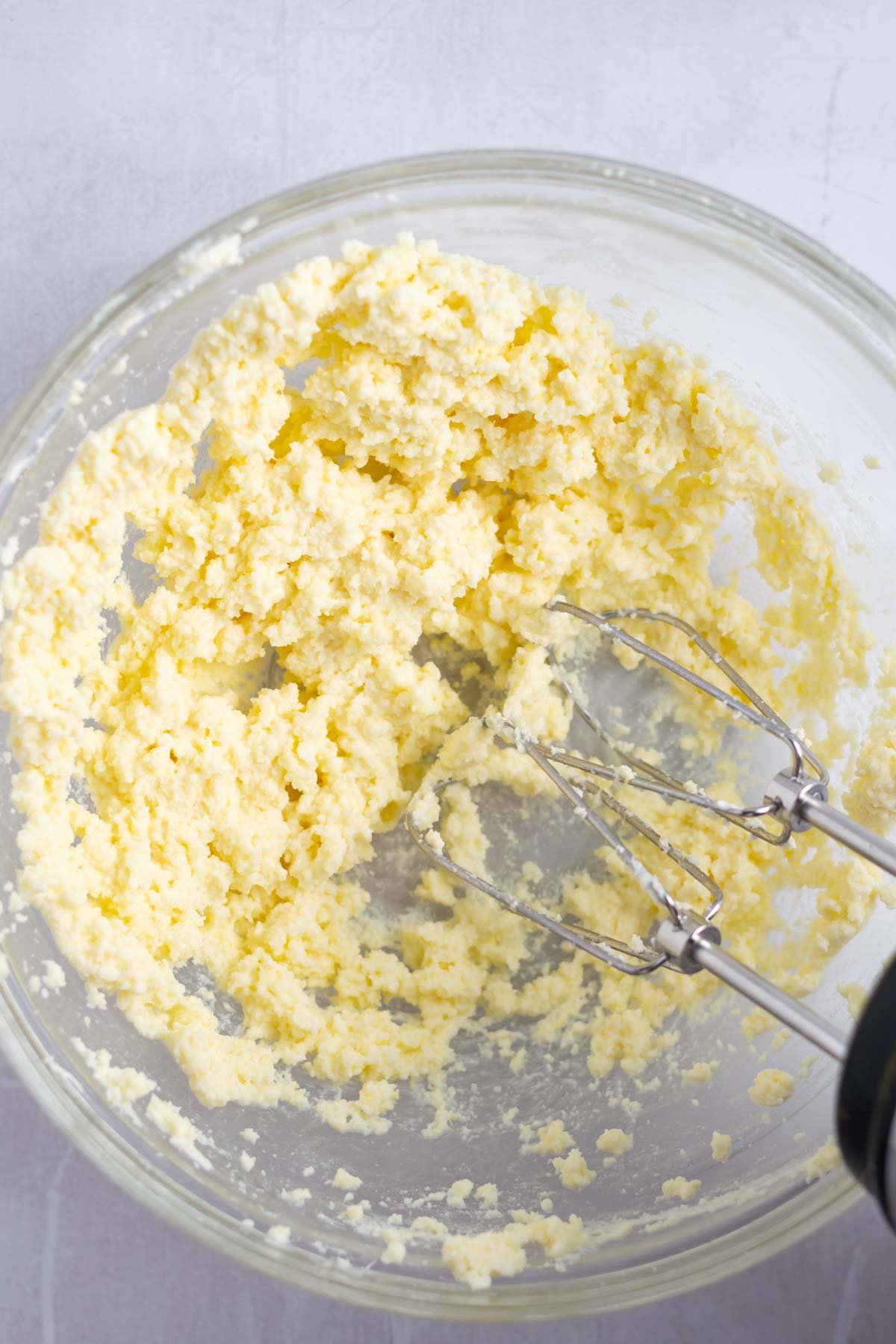 lemon mascarpone ingredients being whipped in a mixing bowl