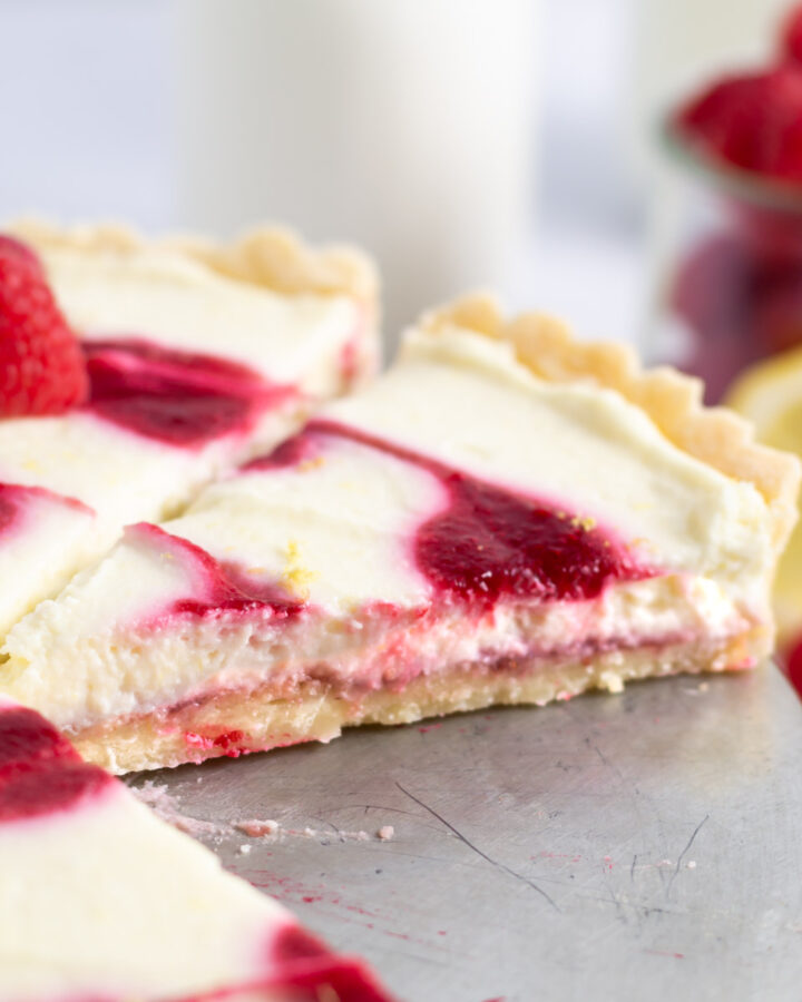 slice of lemon raspberry tart showing the layers