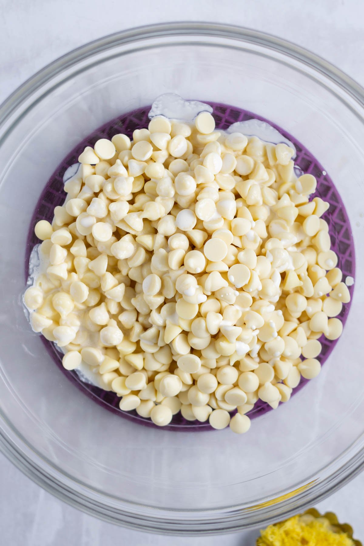 white chocolate chips and heavy cream in a bowl