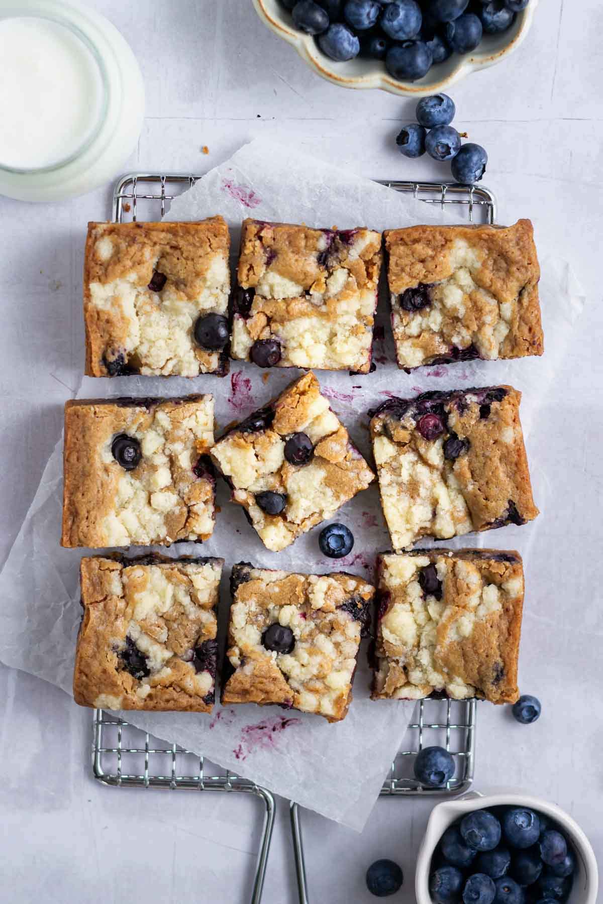blueberry blondies on a parchment lined cooling rack