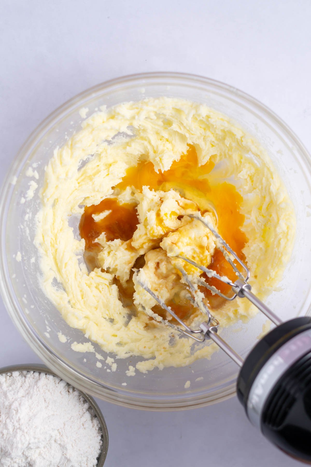 egg and vanilla added to creamed butter and sugar in a bowl