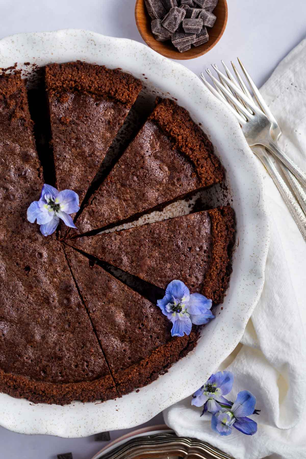 Slices of brownie pie in a pie pan with blue flowers