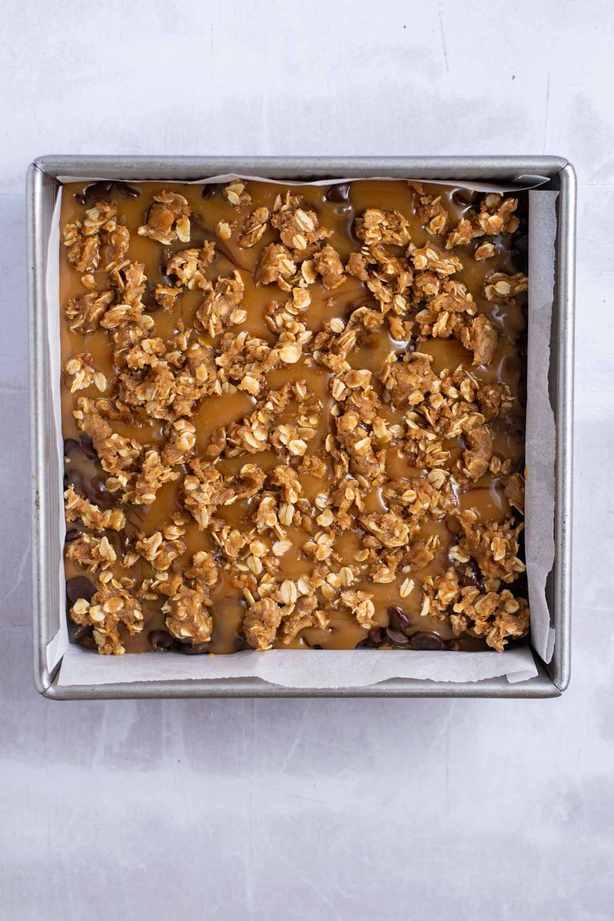 oat topping sprinkled over the caramel and chocolate layer
