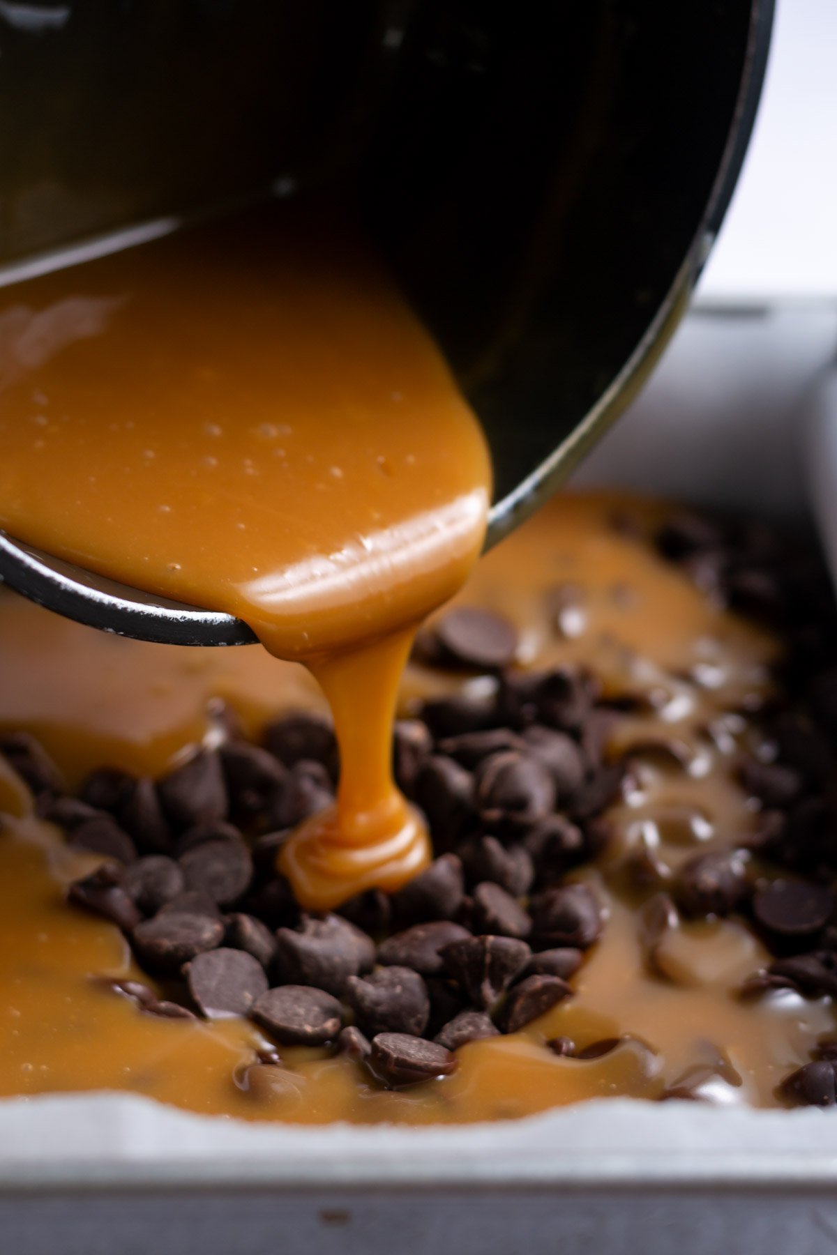 caramel being poured onto chocolate chips
