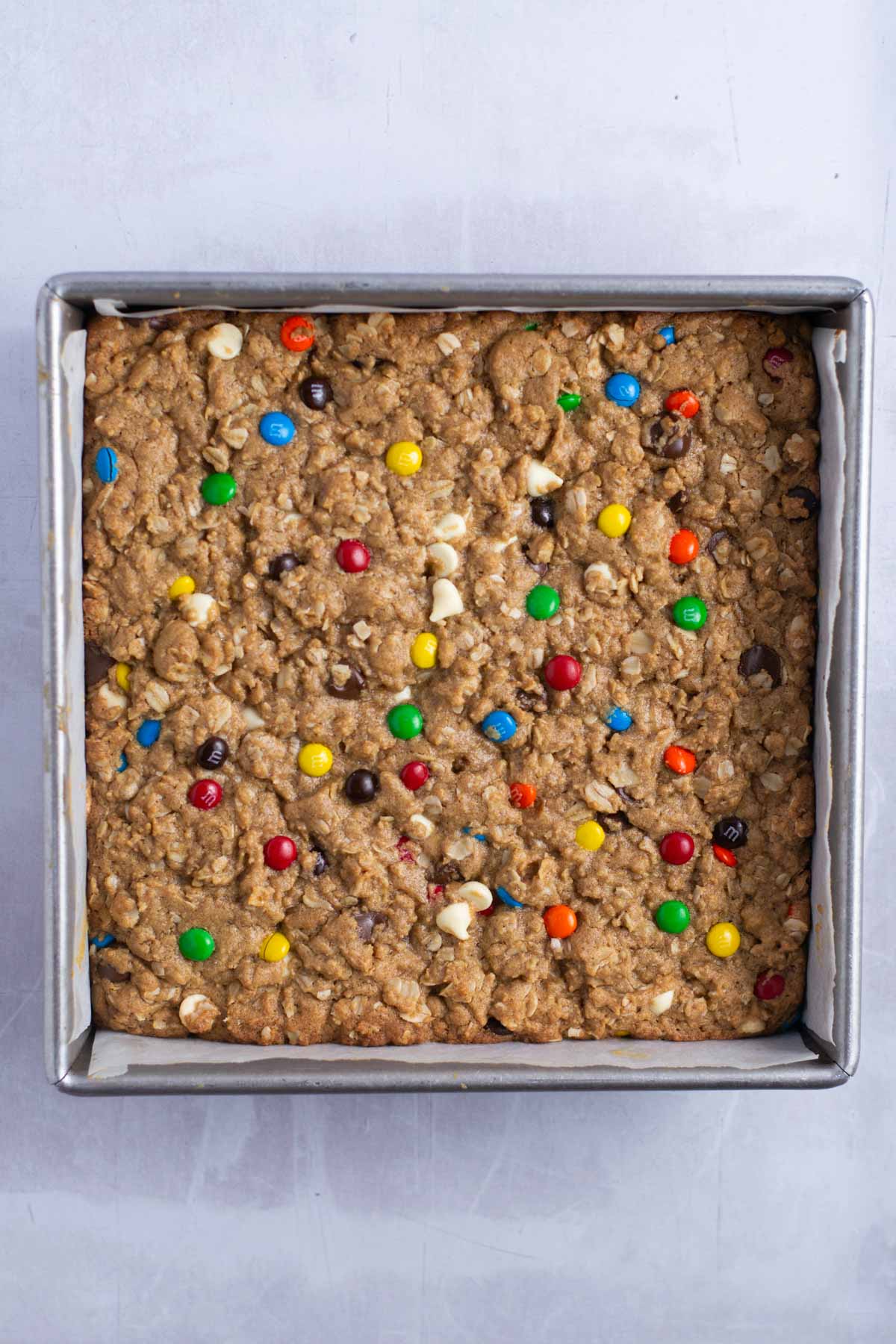 baked monster cookie bars in a baking tin