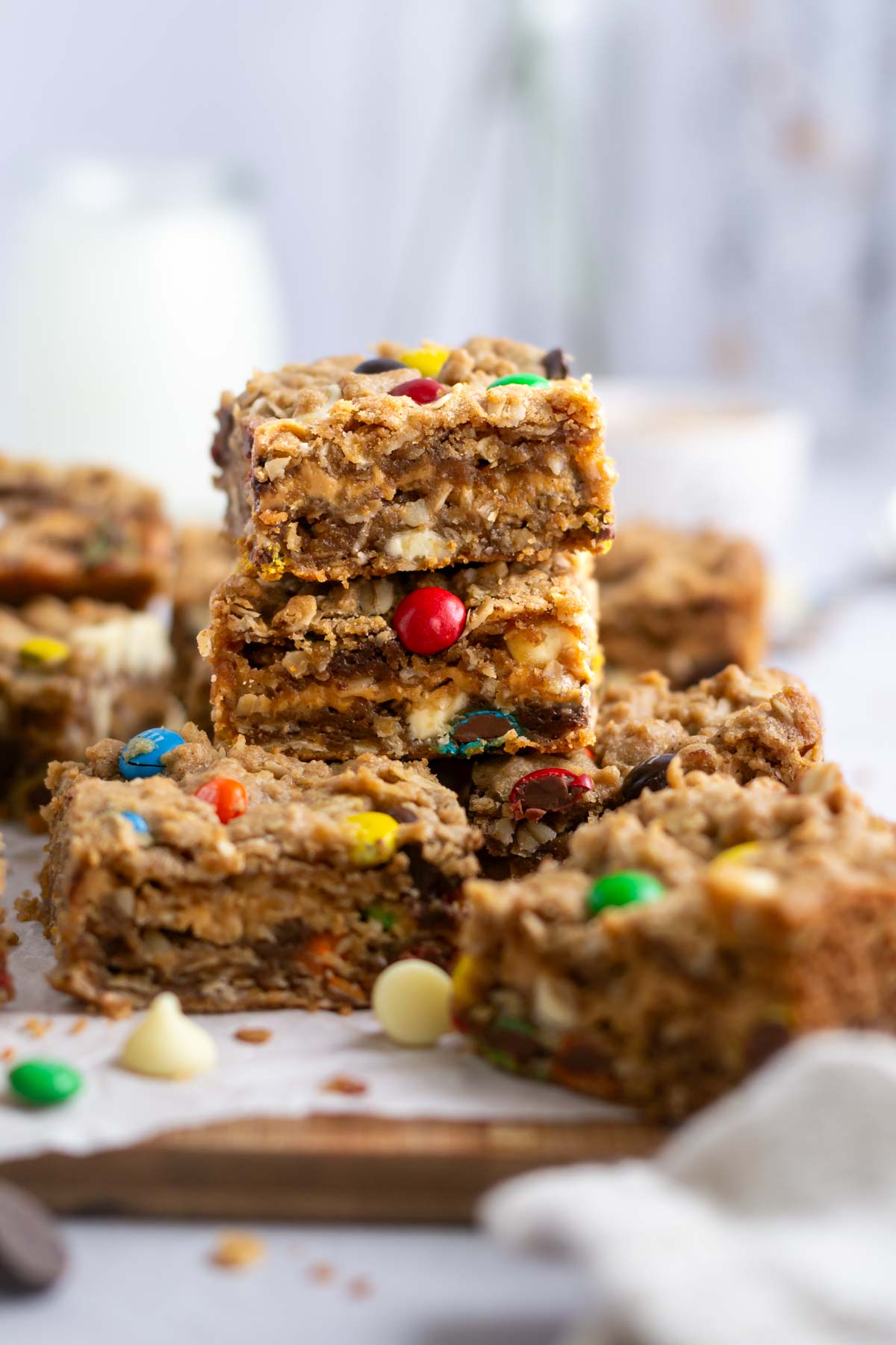 stack of cookie bars with milk in the background