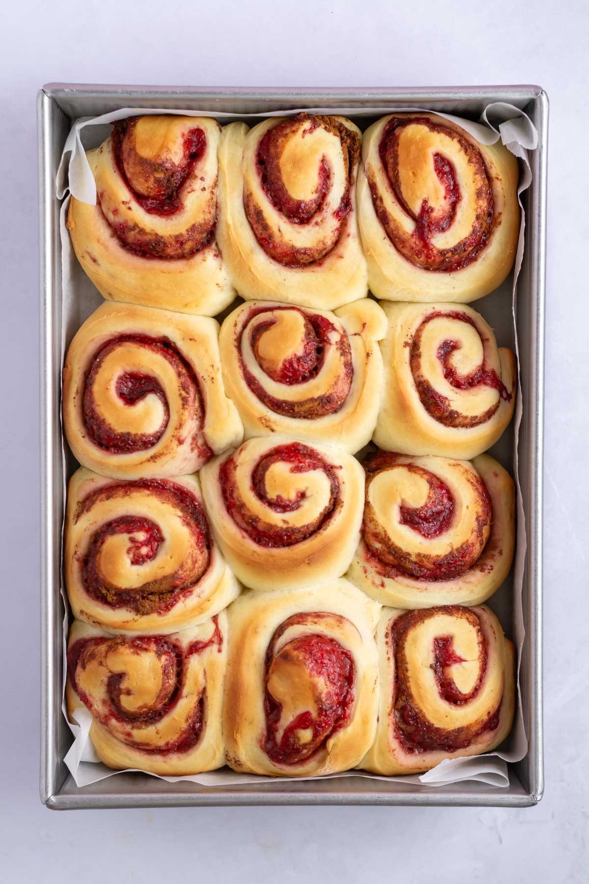 baked strawberry cinnamon rolls in a pan