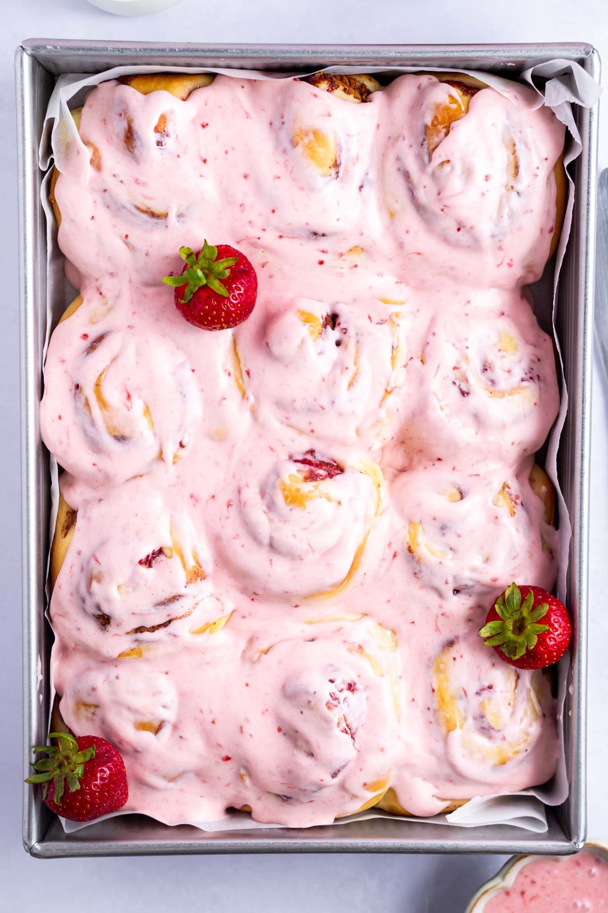 strawberry iced rolls in a baking pan