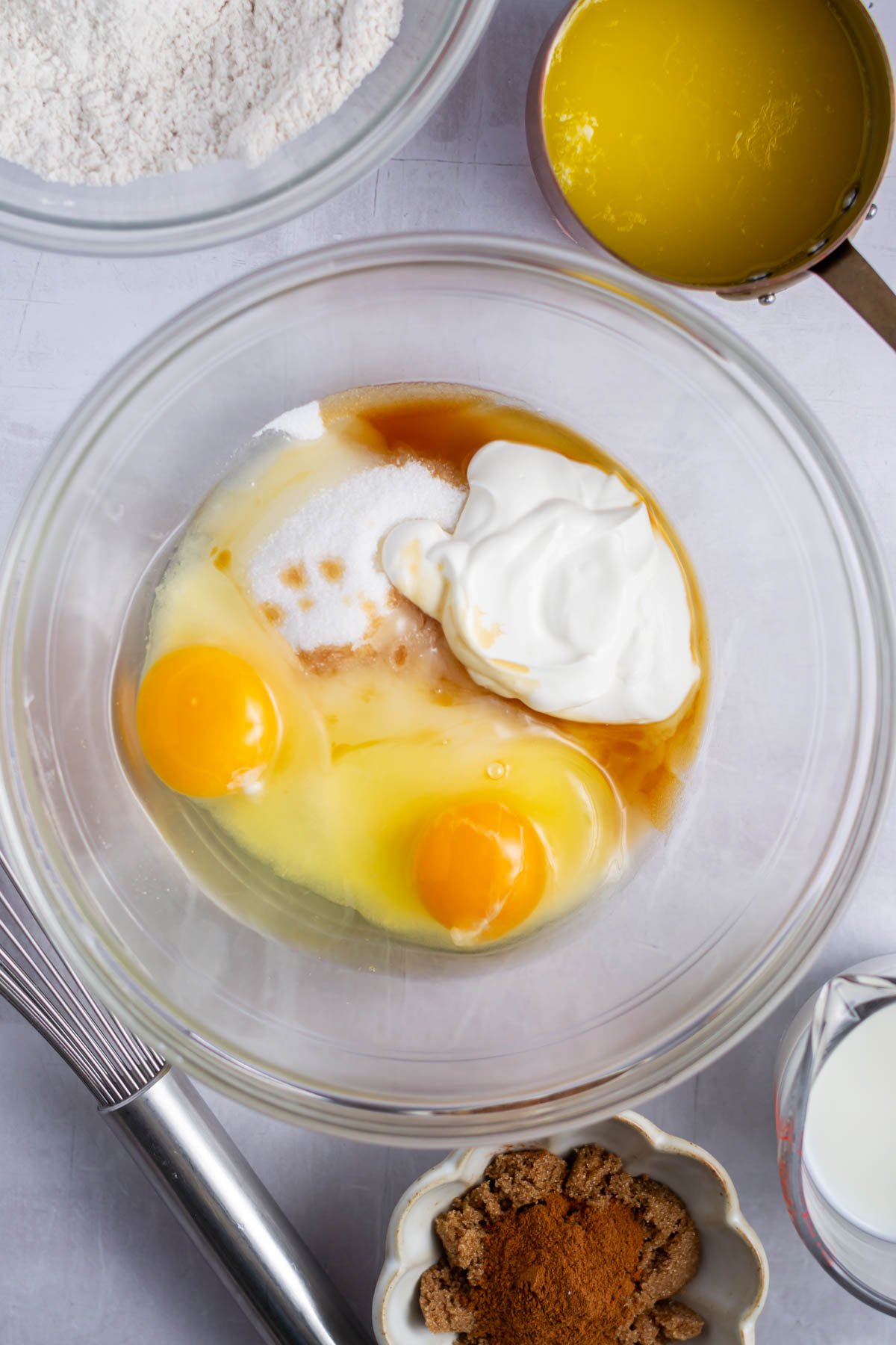 sugar, eggs, vanilla and sour cream in a bowl