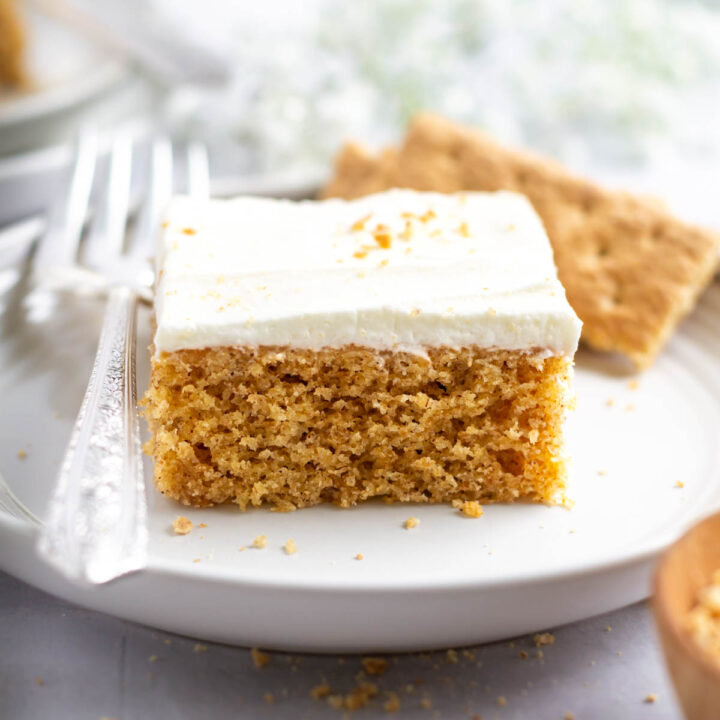slice of graham cracker cake on a plate with a fork