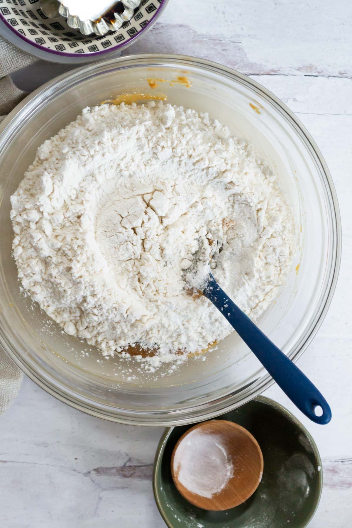 flour added to wet ingredients in a mixing bowl