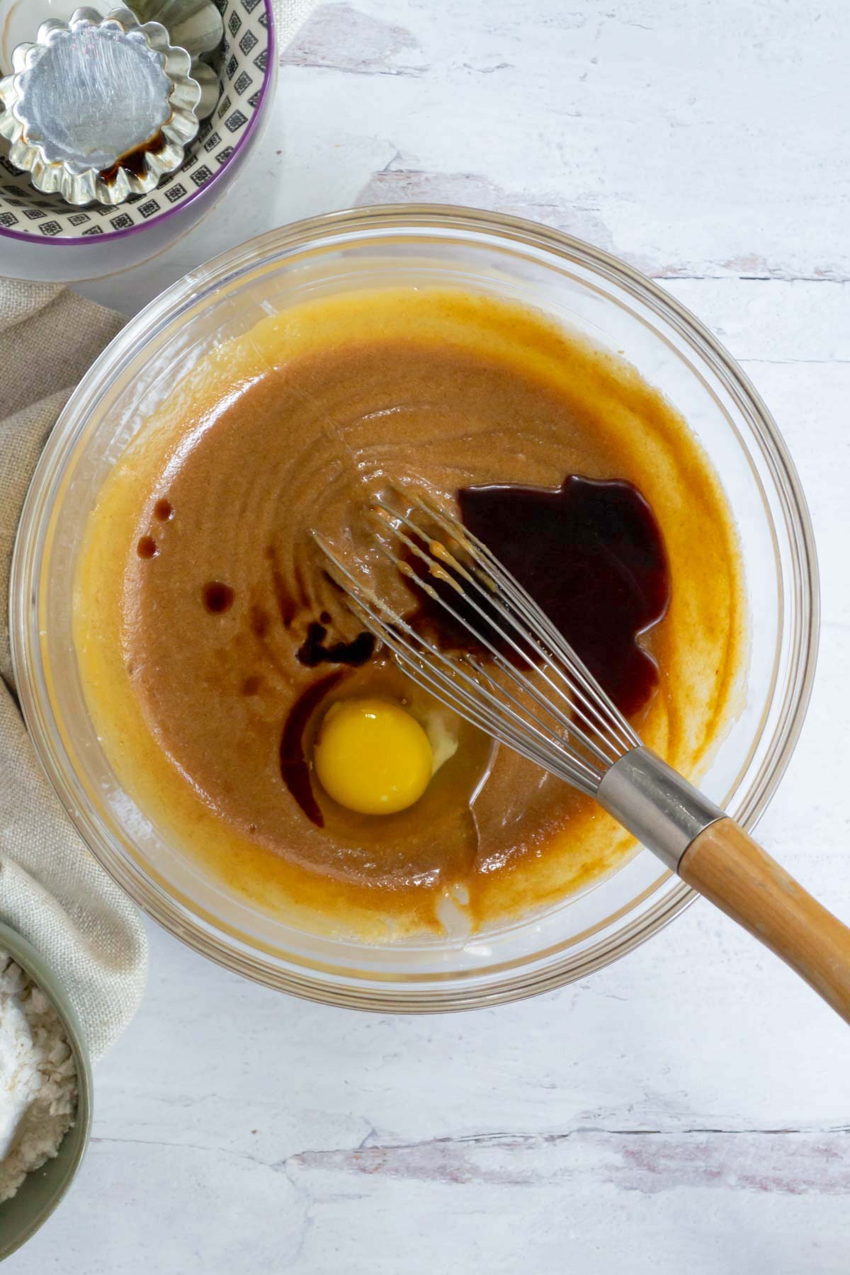 vanilla and an egg added to mixed butter, peanut butter and sugars in a mixing bowl