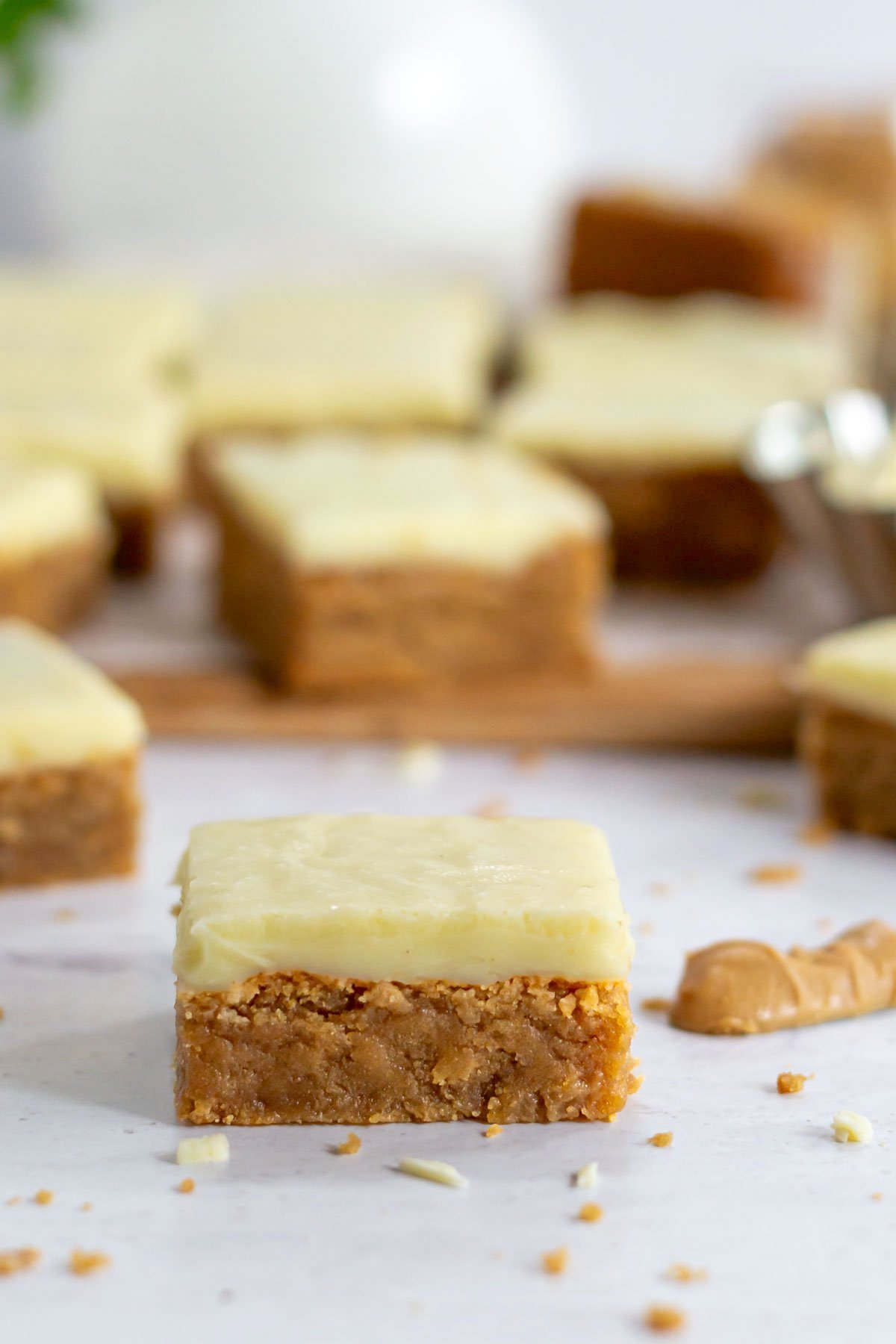 peanut butter blondie sitting on a counter with a knife full of peanut butter