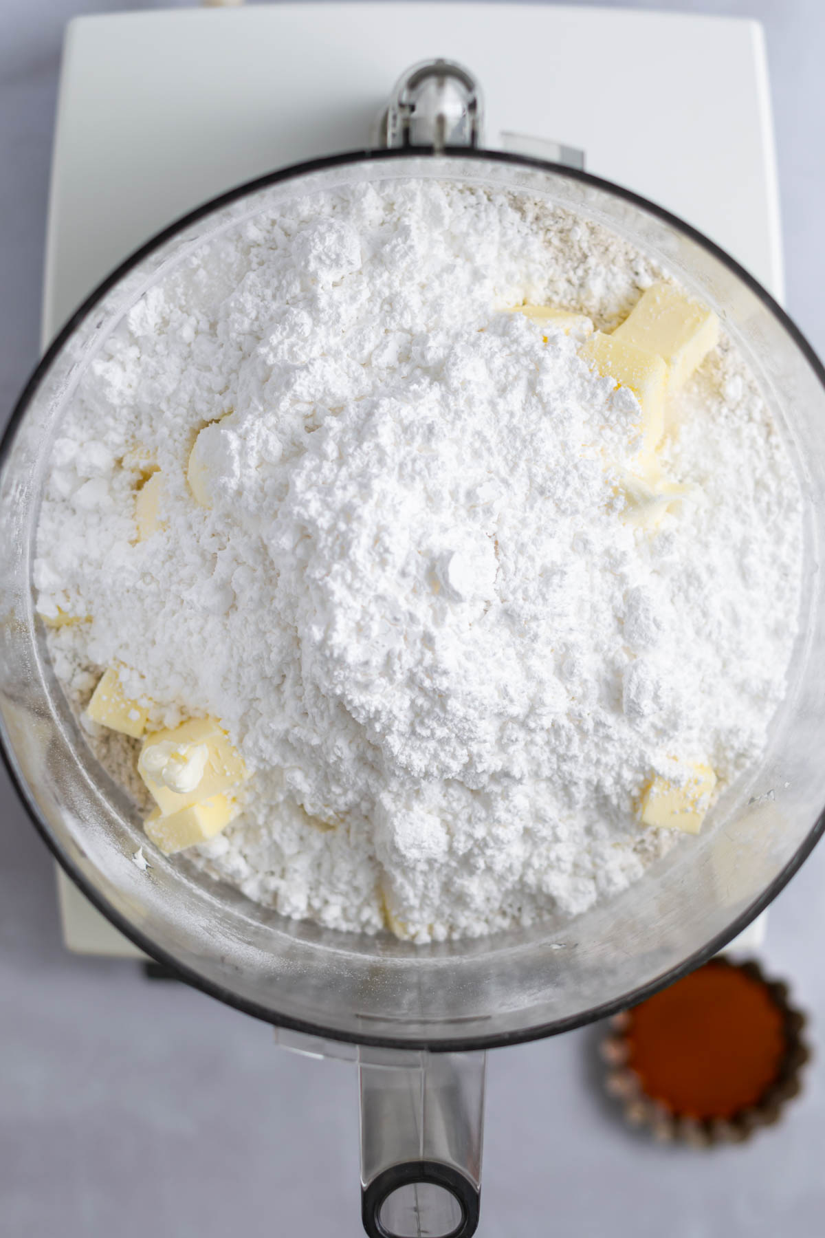 granulated and powdered sugar added to food processor bowl