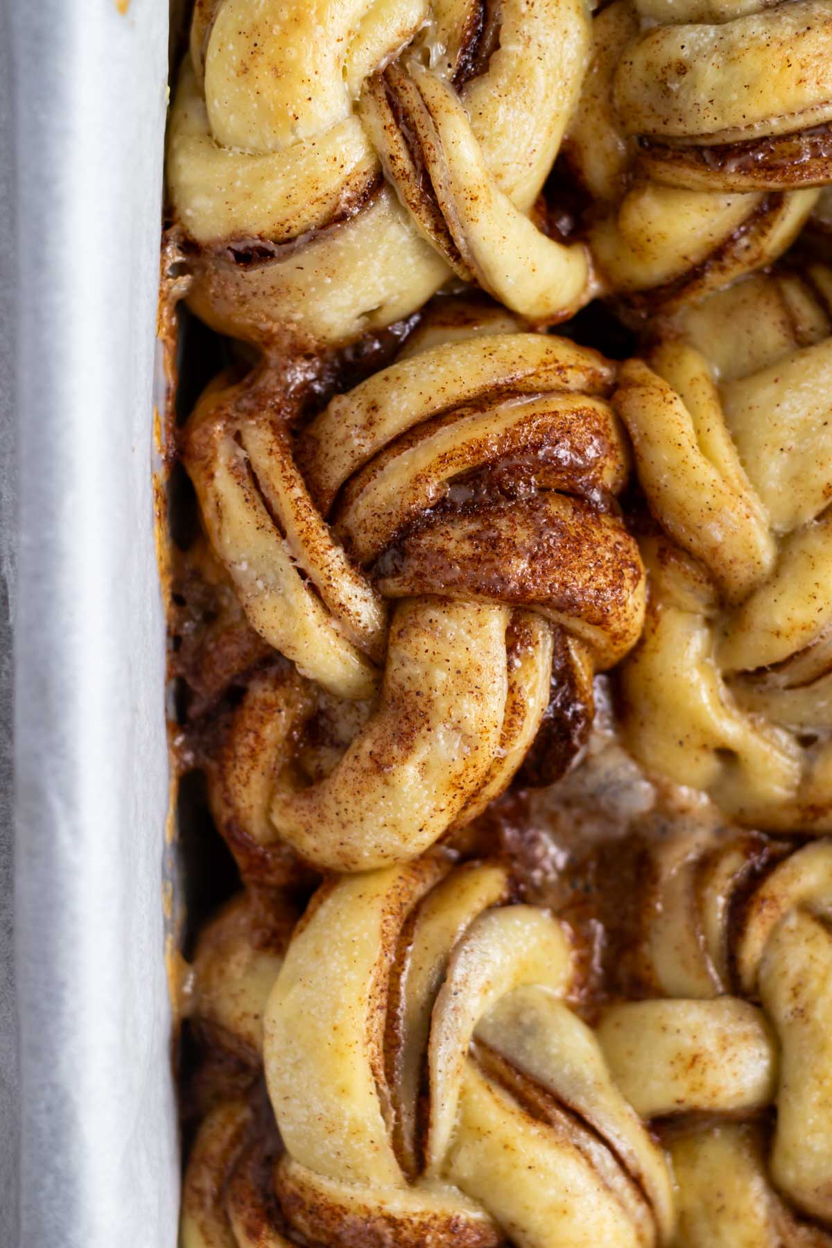 baked cinnamon rolls in a parchment lined loaf pan