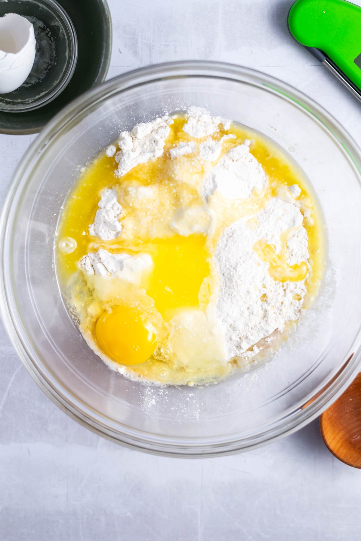 melted butter, egg and flour added to yeast mixture in a bowl