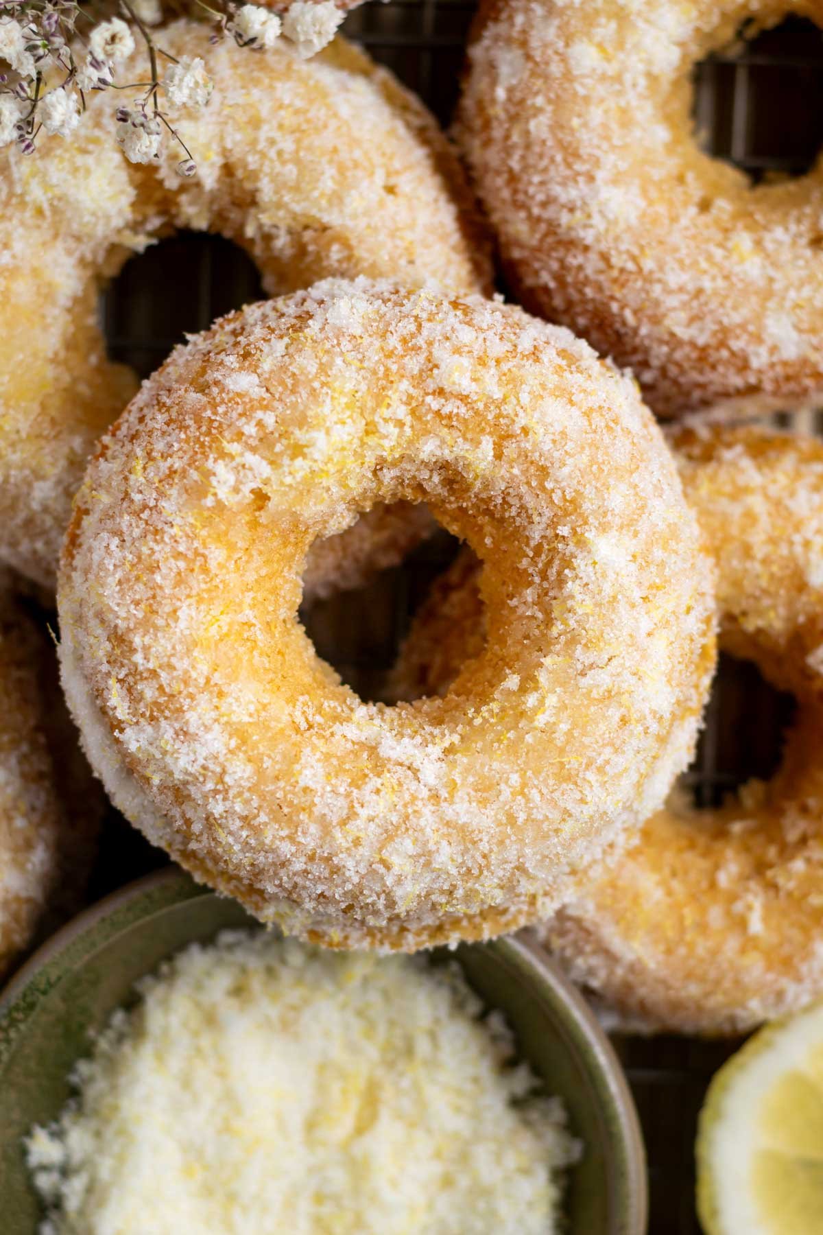 lemon donuts with a bowl of lemon sugar