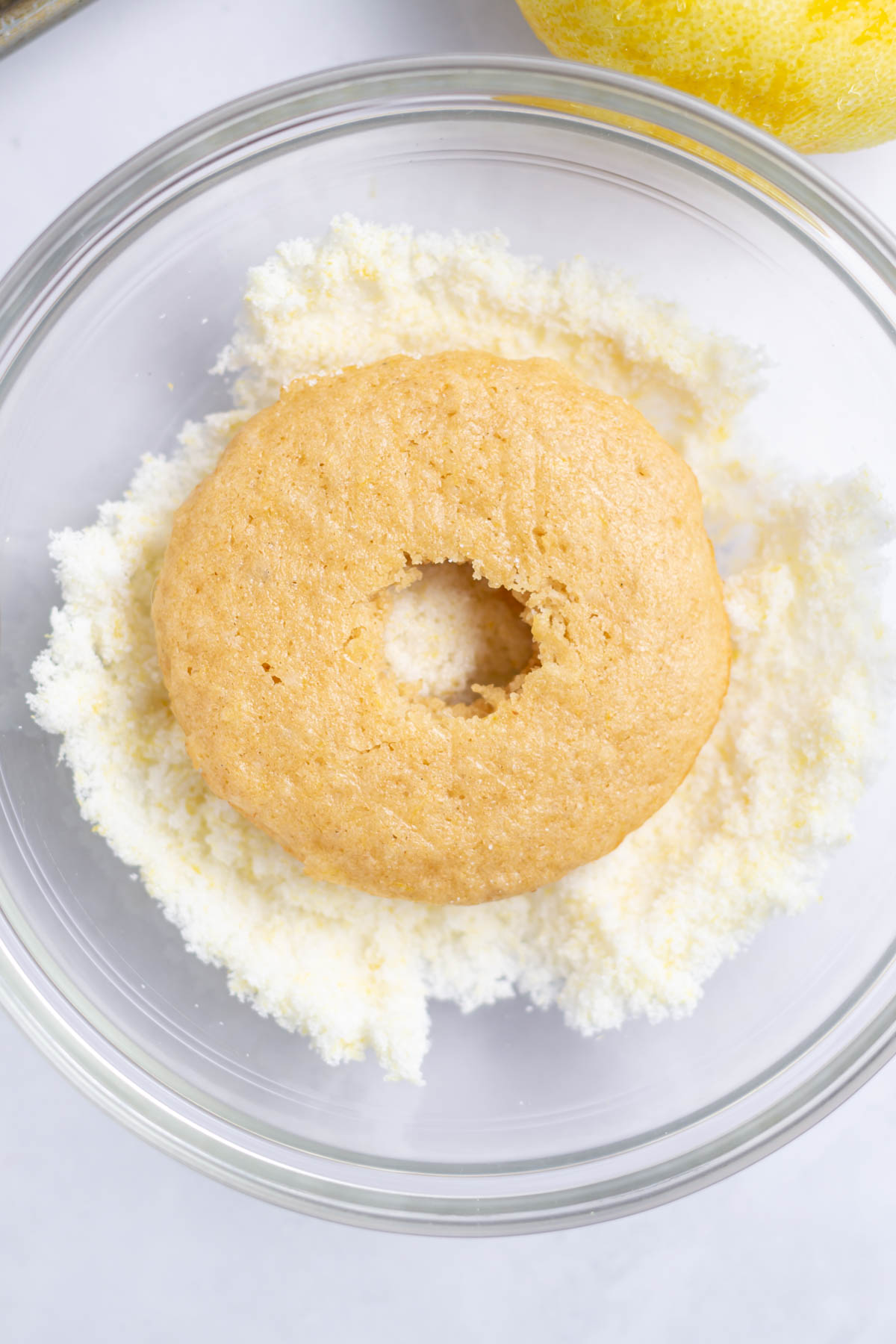 donut in a bowl of lemon sugar