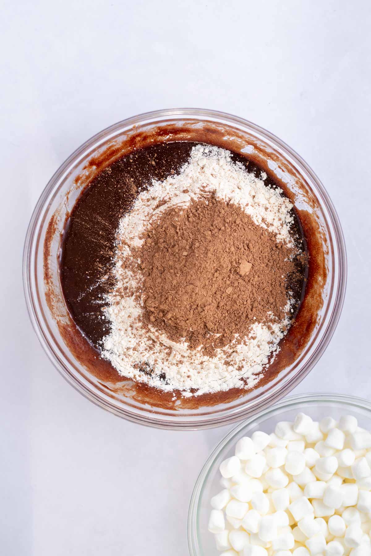 flour and cocoa powder added to brownie batter