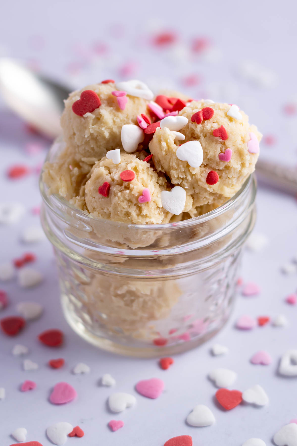 cookie dough bites with valentine sprinkles in a glass dish