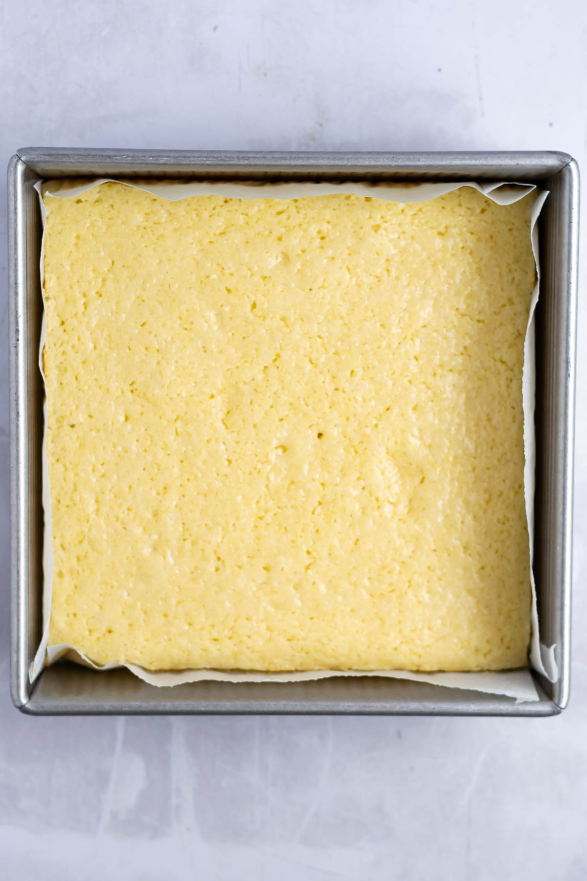 baked lemon snack cake in an 8x8 pan