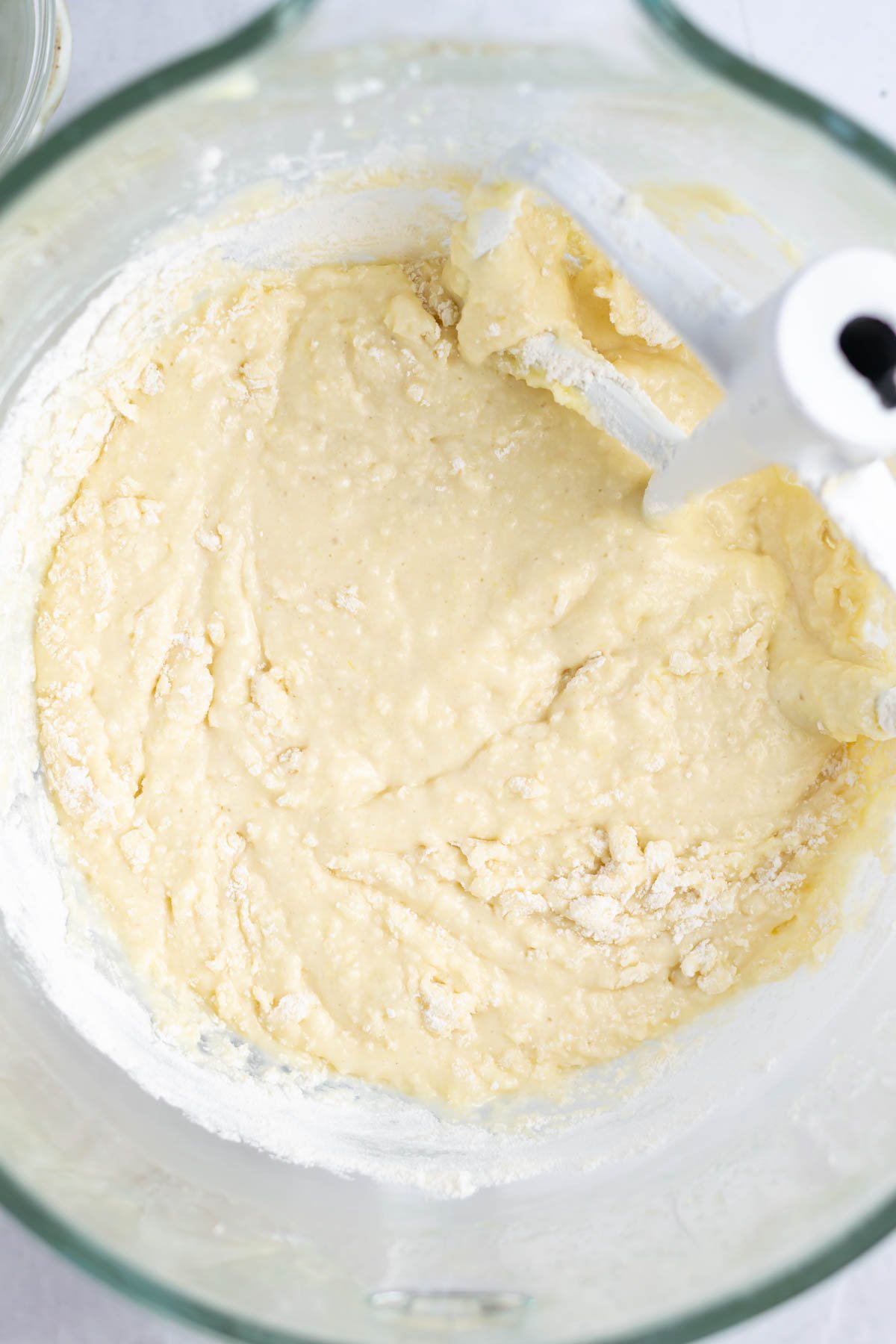 a few streaks of flour remaining in the lemon cake batter in a mixing bowl