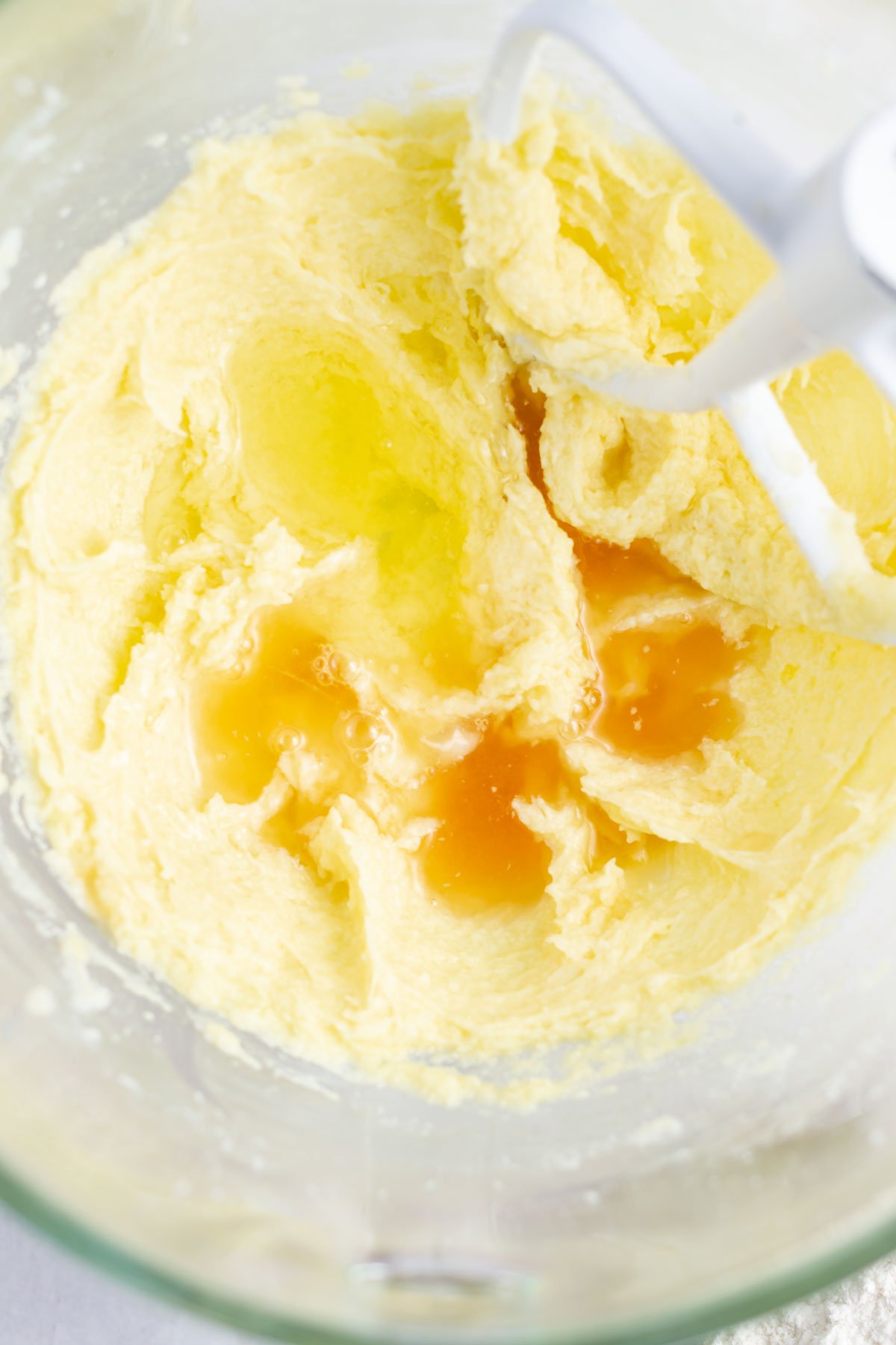 egg yolk, vanilla and lemon juice added to the creamed butter and sugar in a mixing bowl