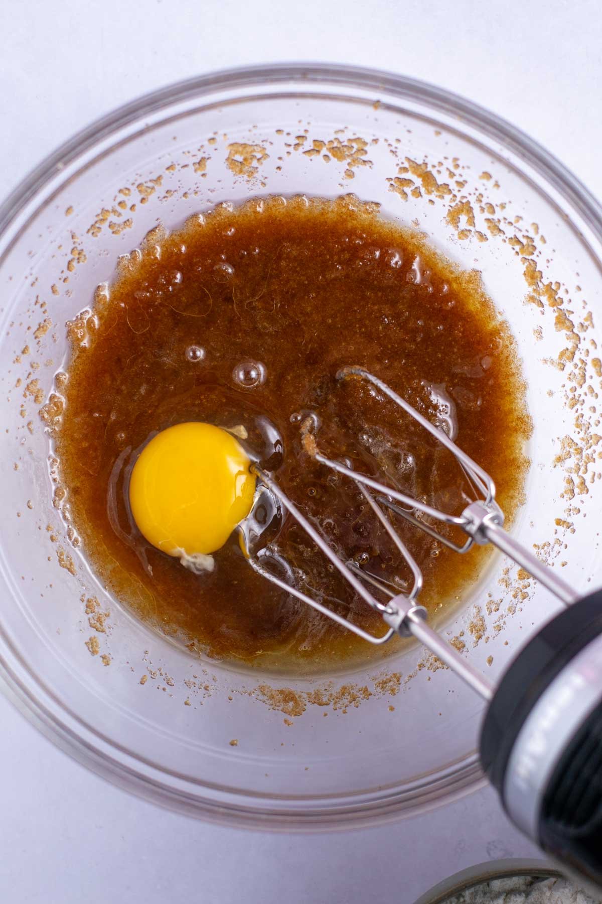 egg and vanilla added to butter and sugar in a mixing bowl