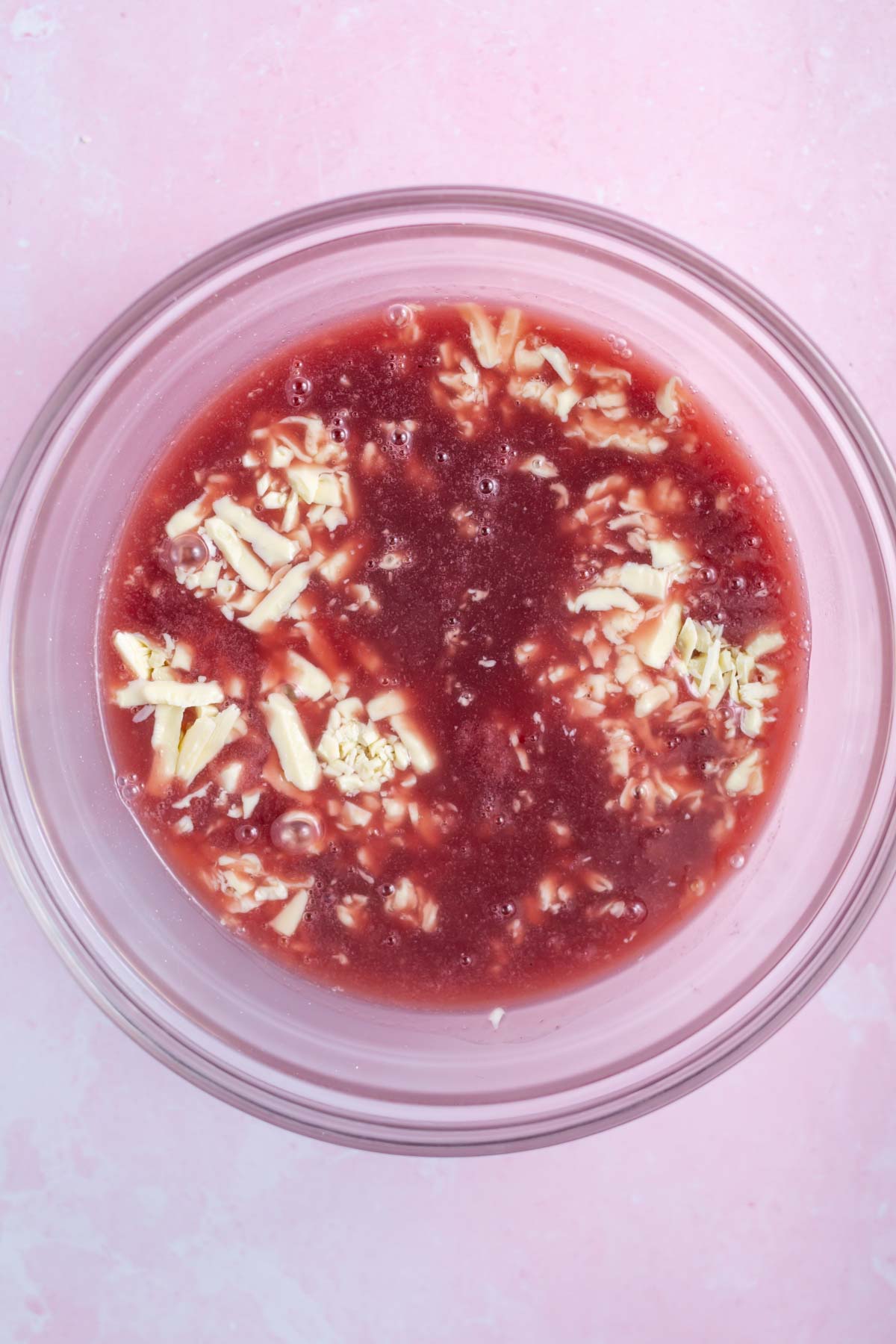 chopped white chocolate and raspberry cream in a mixing bowl