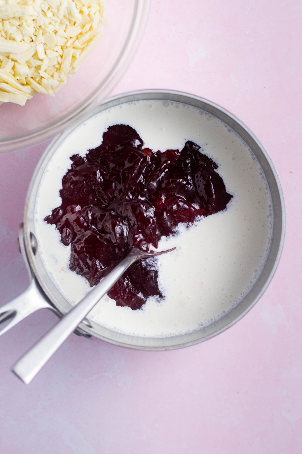 heavy cream and seedless raspberry jam in a saucepan