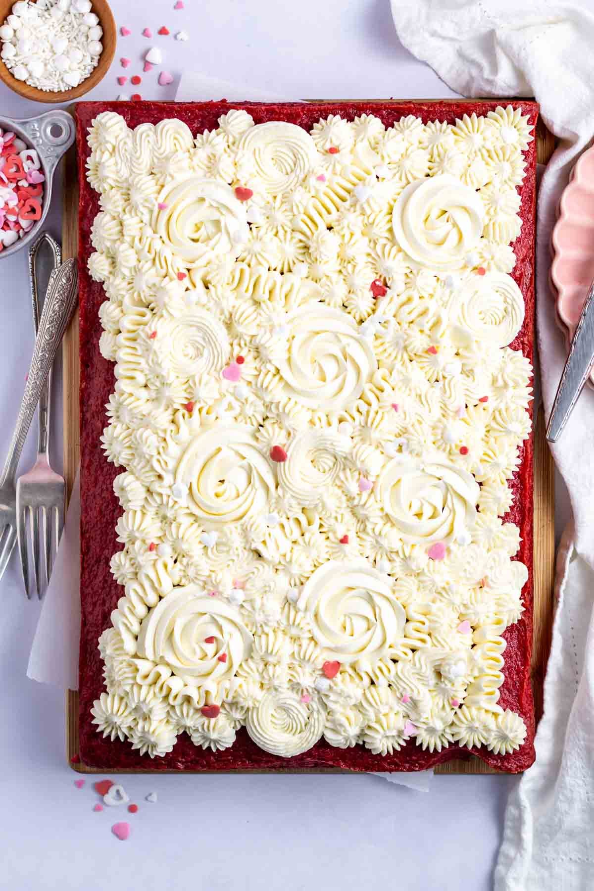 decorated cake with sprinkles and plates and forks
