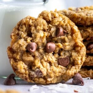 coconut oatmeal cookie next to a glass of milk