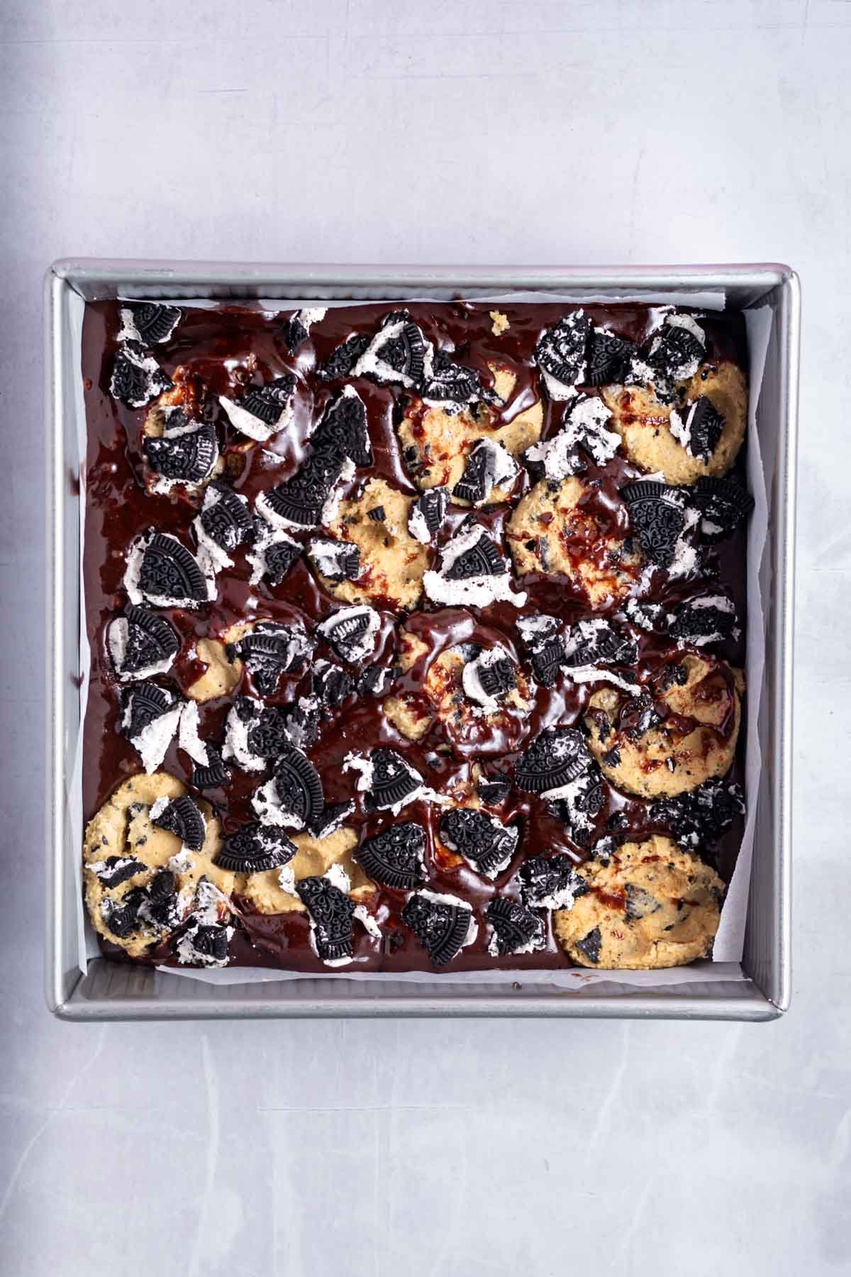 oreo brookie batter in a baking tin before baking