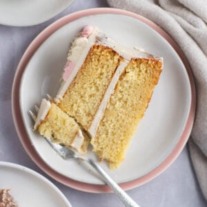 slice of vanilla bean cake on a plate with a fork
