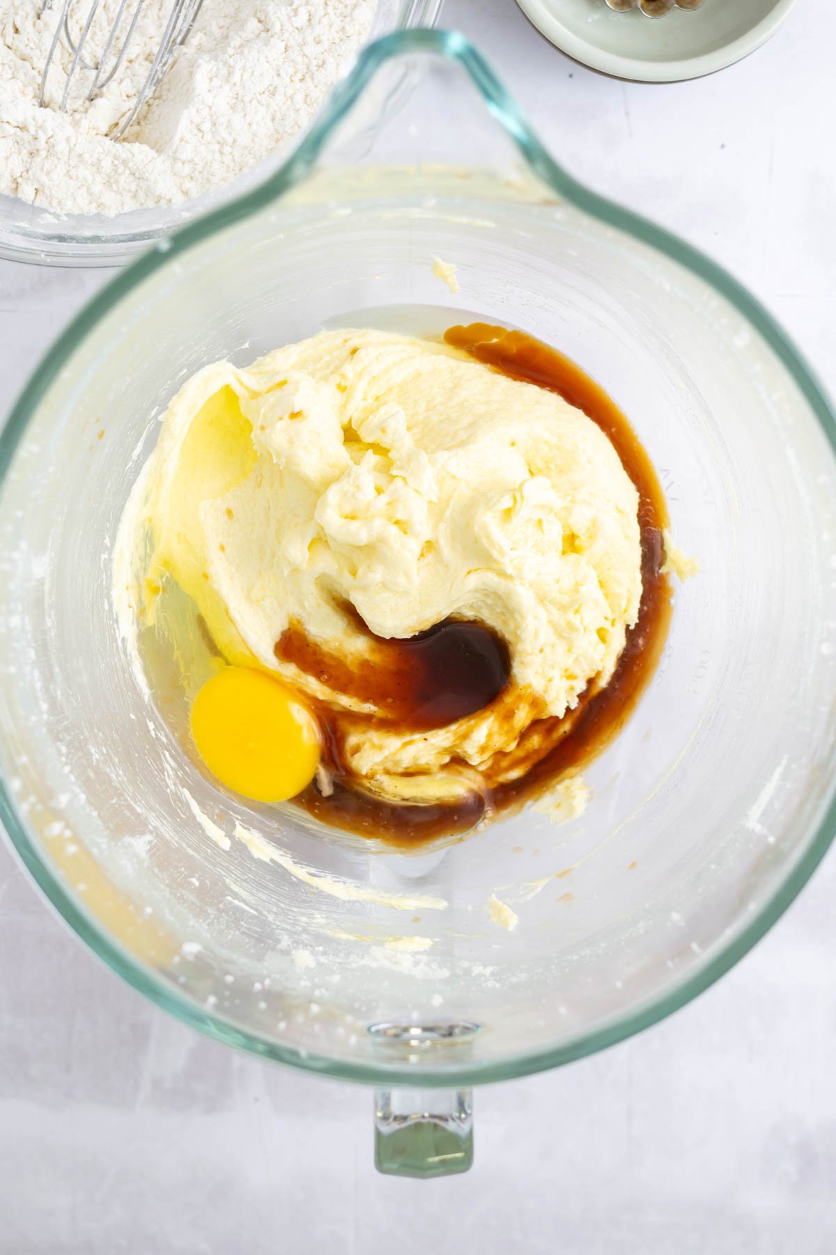vanilla bean paste, vanilla and final egg added to the wet cake ingredients in a mixing bowl