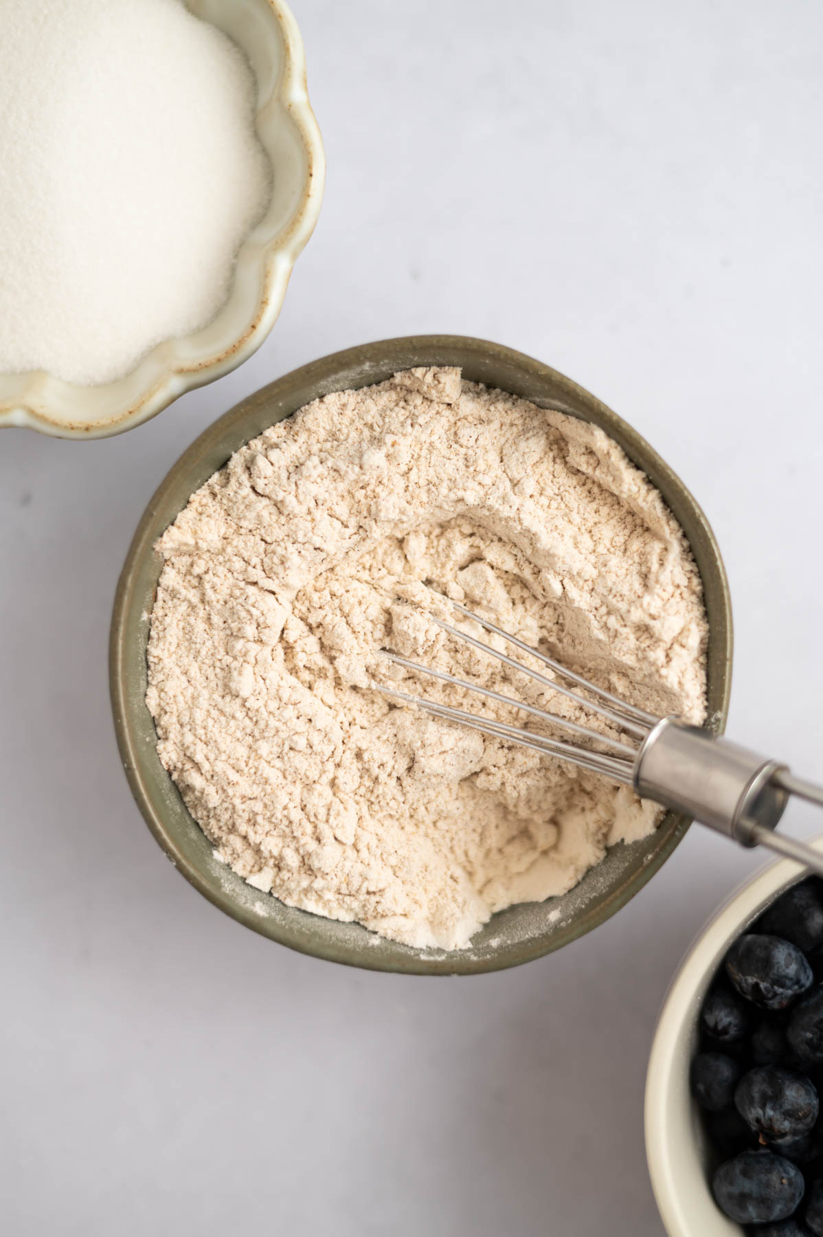 all-purpose and whole wheat flour in a bowl with a whisk