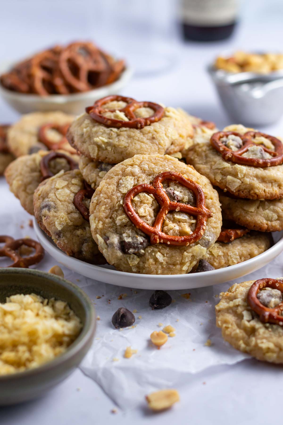 plate of cookies with pretzels and peanuts in the background
