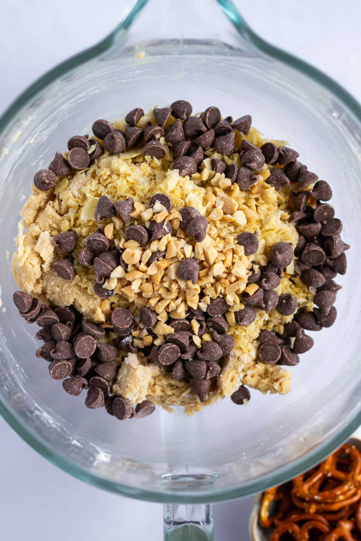 chocolate chips, peanuts and potato chips on top of cookie dough