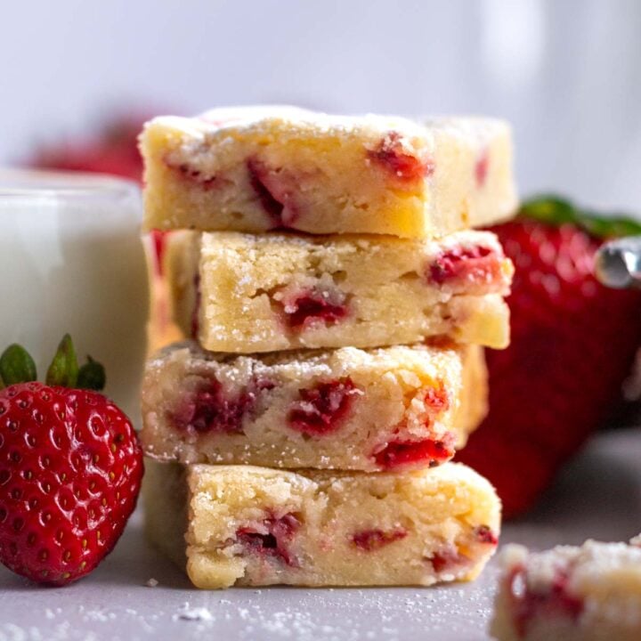 stack of blondie bars with fresh strawberries