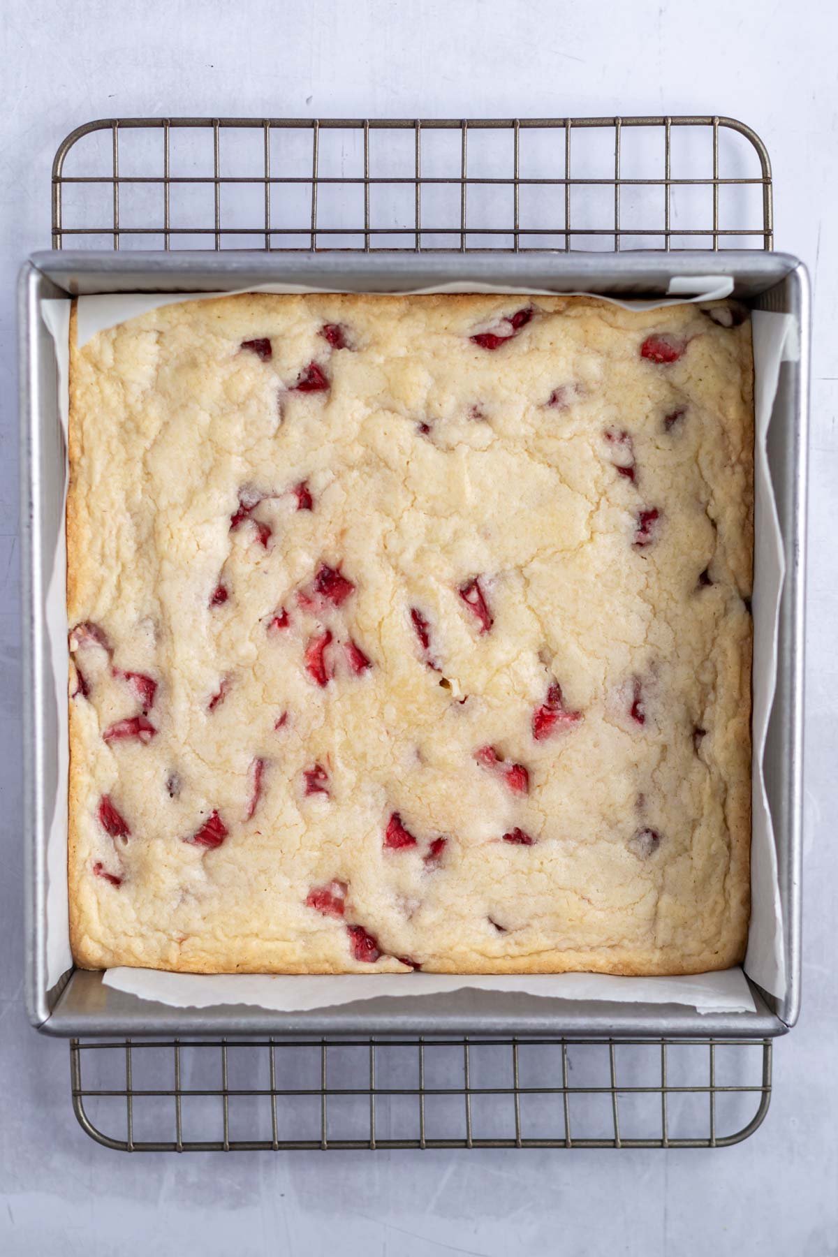baked strawberry blondies on a cooling rack