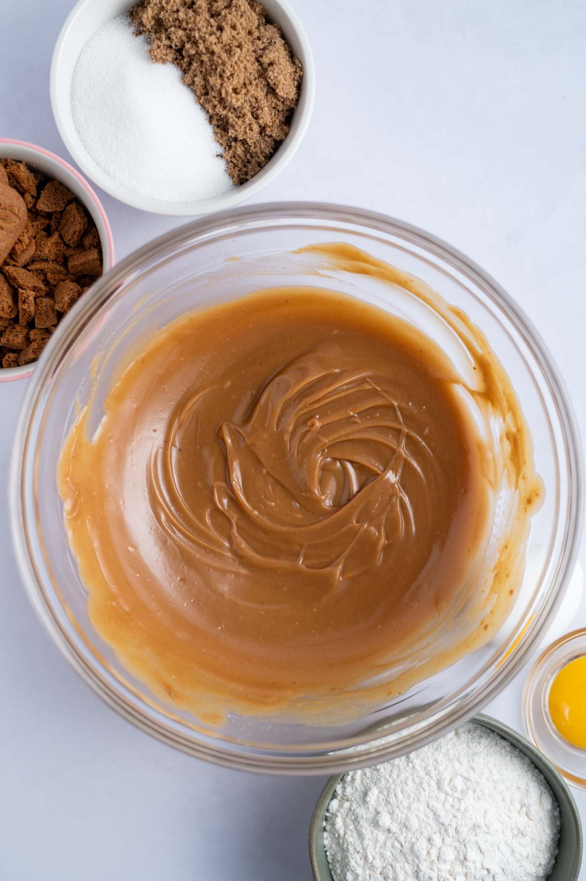 creamy cookie butter and melted butter whisked together in a bowl