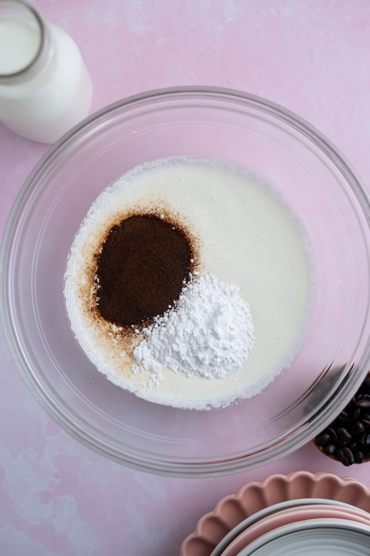 espresso powder, confectioners sugar and whipping cream in a bowl